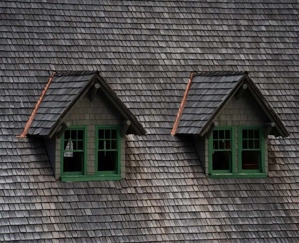 Dormers on a shingle roof in Gilroy, CA, where step flashing and kickout flashing carry water past the walls