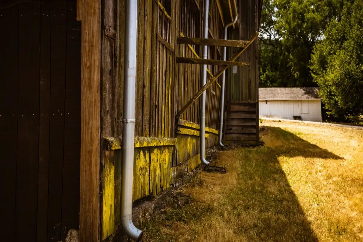 Downspout discharging beside a foundation wall on a house in Gilroy, CA